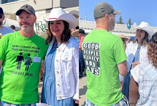 Alberta-Premier-Danielle-Smith-poses-with-a-man-wearing-shirt-that-is-receiving-pushback-online-scaled.jpg